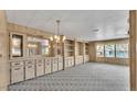 Living room featuring wood paneled walls, built-in shelving, and large windows at 1602 Tally Ho Dr, Lakeland, FL 33810