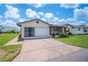 Inviting home with a screened-in porch and an attached garage with a wide driveway at 1608 Colonnades N Cir, Lakeland, FL 33811