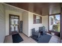 Welcoming screened porch with seating area, creating a cozy and inviting outdoor space at 1608 Colonnades N Cir, Lakeland, FL 33811