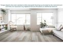 Bright living room featuring vinyl plank flooring, neutral-toned decor, and natural light from large windows at 1826 Daystar Dr, Haines City, FL 33844