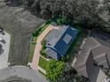Aerial shot of a property highlighting its roof, driveway, landscaping, and proximity to neighboring homes at 184 Melissa Trl, Auburndale, FL 33823