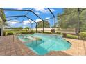 Sparkling in-ground pool with a built-in spa, brick surround, and a screened enclosure for year-round enjoyment at 1902 Altavista Cir, Lakeland, FL 33810