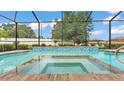 Inviting in-ground pool with a spa and a black mesh screen, perfect for outdoor relaxation and entertaining at 1902 Altavista Cir, Lakeland, FL 33810