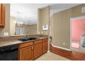 Open-concept kitchen featuring a dual sink, granite countertop, and views of the dining and bedrooms at 2061 Crestdale Ln # 60, Lake Mary, FL 32746