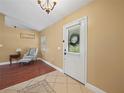 Inviting entryway with tile and wood flooring, decorative chair, and a view to the front yard at 2921 W Socrum Loop Rd, Lakeland, FL 33810