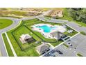 Aerial view of the community pool, playground, parking, and construction sites at 2966 Flying Blackbird Rd, Bartow, FL 33830