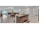 Open-concept kitchen featuring granite countertops, an island, and stainless steel appliances at 2966 Flying Blackbird Rd, Bartow, FL 33830