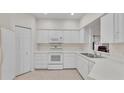 Clean kitchen with white cabinets and modern appliances. Lots of storage space at 3107 Stonewater Dr, Lakeland, FL 33803