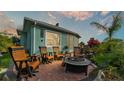 Outdoor patio area with comfortable seating and a cozy fire pit at 3270 Green Heron Dr, Polk City, FL 33868