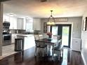 Bright kitchen with stainless steel appliances, white cabinetry, and a cozy dining area at 3646 Sherertz Road, Lakeland, FL 33810