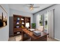 Stylish home office with custom wood shelving, desk, and window views create an ideal work environment at 4088 Prima Lago Cir, Lakeland, FL 33810