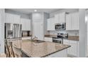 Modern kitchen features stainless steel appliances, granite countertops, and white cabinetry at 4088 Prima Lago Cir, Lakeland, FL 33810