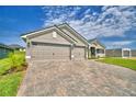 Spacious three-car garage and wide brick driveway, perfect for ample parking at 4300 Juliana Lake Dr, Auburndale, FL 33823