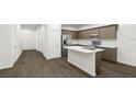 Well-designed kitchen featuring an island, stainless steel appliances, and sleek countertops at 445 Silverbell Trl, St Cloud, FL 34771