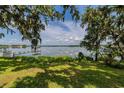 Stunning water view from the backyard, framed by lush trees at 5026 N Socrum Loop Rd, Lakeland, FL 33809