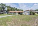 Attractive single-story home with a well-maintained front yard and mature landscaping at 5026 N Socrum Loop Rd, Lakeland, FL 33809