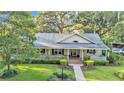 Inviting single-story home with landscaped front yard and charming porch seating at 5108 Waterwood Dr, Bartow, FL 33830