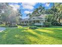 Beautifully landscaped front yard with a spacious lawn and mature trees at 5108 Waterwood Dr, Bartow, FL 33830