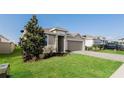 Charming home featuring a manicured lawn, and a two-car garage in a residential neighborhood at 606 Fairview Ave # 244, Haines City, FL 33844