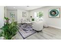 Beautifully staged living room featuring a decorative rug, modern art, and ample natural light at 6338 Oak E Sq, Lakeland, FL 33813