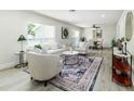 Bright and inviting living room featuring modern decor, ample seating, and large windows with natural light at 6338 Oak E Sq, Lakeland, FL 33813
