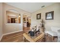 Cozy living room featuring elegant arched doorways, wood floors, and stylish décor at 6339 Alamanda Hills Dr, Lakeland, FL 33813