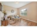 Comfortable sitting area with a large window, wood-look floors, and tasteful furniture at 6339 Alamanda Hills Dr, Lakeland, FL 33813