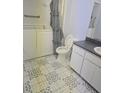 Functional bathroom with safety tub, vanity, and patterned tile flooring at 6632 Sweetbriar Ln, Lakeland, FL 33813