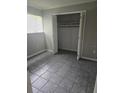 Bedroom with tiled floor, closet with open doors, and ample natural light at 6632 Sweetbriar Ln, Lakeland, FL 33813