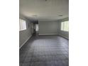 Spacious living room with tile floors and natural light, offering a versatile space for relaxation at 6632 Sweetbriar Ln, Lakeland, FL 33813