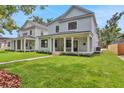 Charming home featuring a covered porch and lush lawn in a serene neighborhood setting at 727 S Missouri Ave, Lakeland, FL 33815