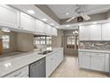 Bright kitchen featuring stainless steel appliances, white cabinetry, and quartz countertops at 7932 Ridge Pointe W Dr, Lakeland, FL 33810