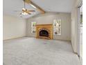 Spacious living room featuring vaulted ceilings, a brick fireplace, and access to the outdoors at 7932 Ridge Pointe W Dr, Lakeland, FL 33810