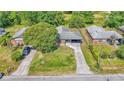 Aerial view of home with a well-manicured lawn and convenient carport in a suburban neighborhood at 1017 Fleming Ave, Lakeland, FL 33815