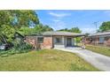 Charming single-story brick home with a covered carport and a well-maintained front yard at 1017 Fleming Ave, Lakeland, FL 33815