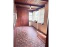 Cozy sun room with unique tile flooring, wood-paneled walls, and natural light, perfect for relaxing at 1215 E Edgewood Dr, Lakeland, FL 33803