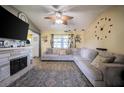 Cozy living room featuring a decorative fireplace and a large sectional sofa at 1434 Country Ridge Dr, Lakeland, FL 33801