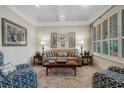 Comfortable living room with tray ceiling, shutters, stylish furnishings, and natural light at 1825 Pawnee Trl, Lakeland, FL 33803