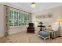 Cozy sitting area with comfortable seating, plantation shutters, and ample natural light at 1825 Pawnee Trl, Lakeland, FL 33803