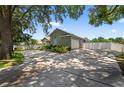View of the home's exterior showcasing a wide driveway and attached two car garage at 1922 Matthew Ct, Lakeland, FL 33813