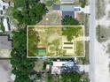 Aerial view of the property, showing the home, sheds, and surrounding land in a rural setting at 2120 Dille St, Lakeland, FL 33815