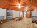 Spacious bonus room with wood ceilings and flooring, featuring a bed and ample storage space at 2120 Dille St, Lakeland, FL 33815