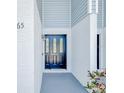 Close-up of the front door, accented by light blue siding and white trim at 222 Carpenters Way # 65, Lakeland, FL 33805