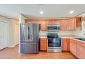 A well-lit kitchen with stainless steel appliances and wood cabinets at 222 Carpenters Way # 65, Lakeland, FL 33805