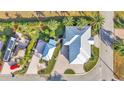 Aerial view of home with detached garage showcasing a luxurious design and lush landscaping at 3287 Red Tail Hawk Dr, Polk City, FL 33868