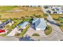 Beautiful aerial view of blue house, with detached garage, expansive drive, and landscaped yard at 3287 Red Tail Hawk Dr, Polk City, FL 33868