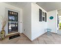 Inviting front porch with decorative tile, potted plants, and a 'hello' welcome mat at 3487 Highland Fairways Blvd, Lakeland, FL 33810