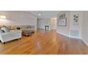 Spacious living room with hardwood floors, neutral walls, and comfortable seating arrangements at 3487 Highland Fairways Blvd, Lakeland, FL 33810