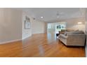 Bright living room with hardwood floors and a comfortable seating area bathed in natural light at 3487 Highland Fairways Blvd, Lakeland, FL 33810