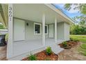 Inviting covered porch with a fresh coat of grey paint and two entry doors leading into the home at 3601 Avenue R Nw, Winter Haven, FL 33881